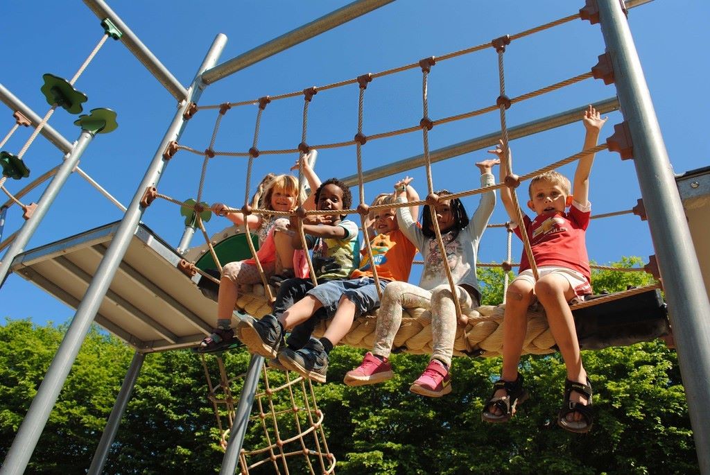 Kids climbing rope on a backyard playground set